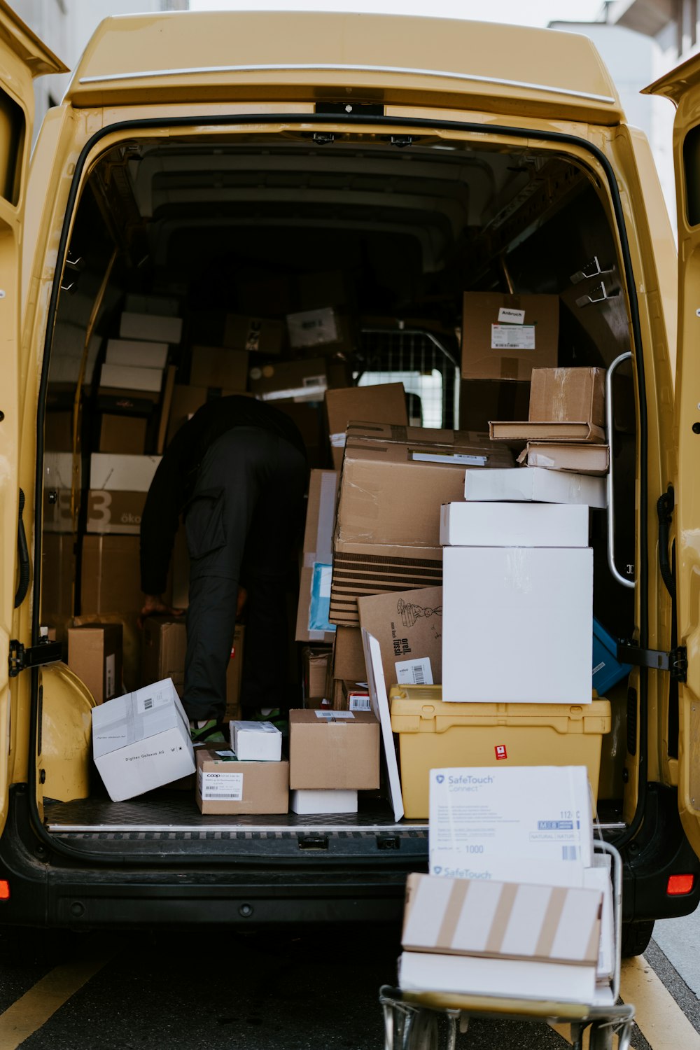 Delivery driver loading a freight van